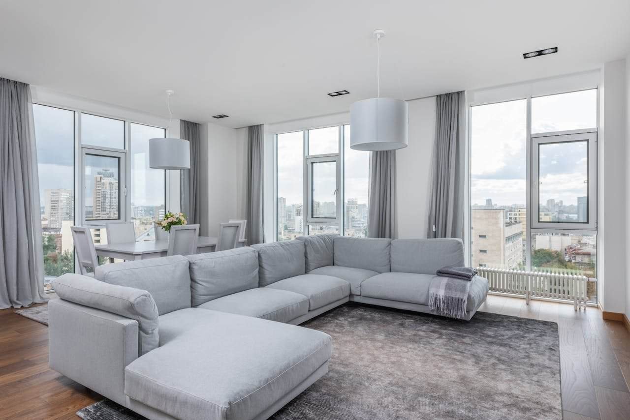 our-story-01 spacious living room with comfortable sofa and panoramic windows 6758521